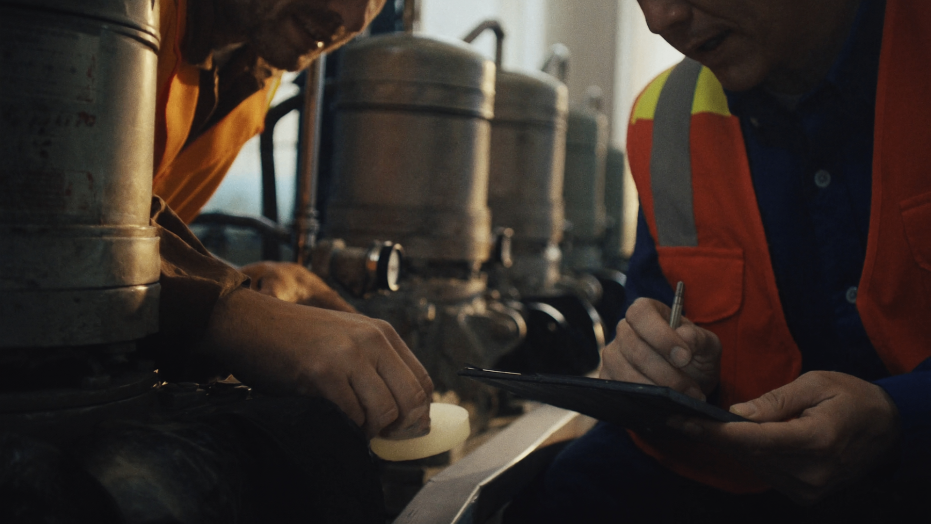 Technicians inspecting industrial pump systems